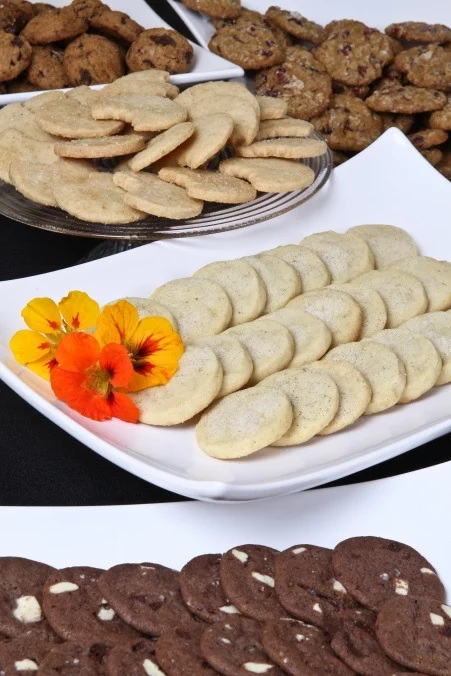 variety of delicious gourmet cookies on platters at a catered event