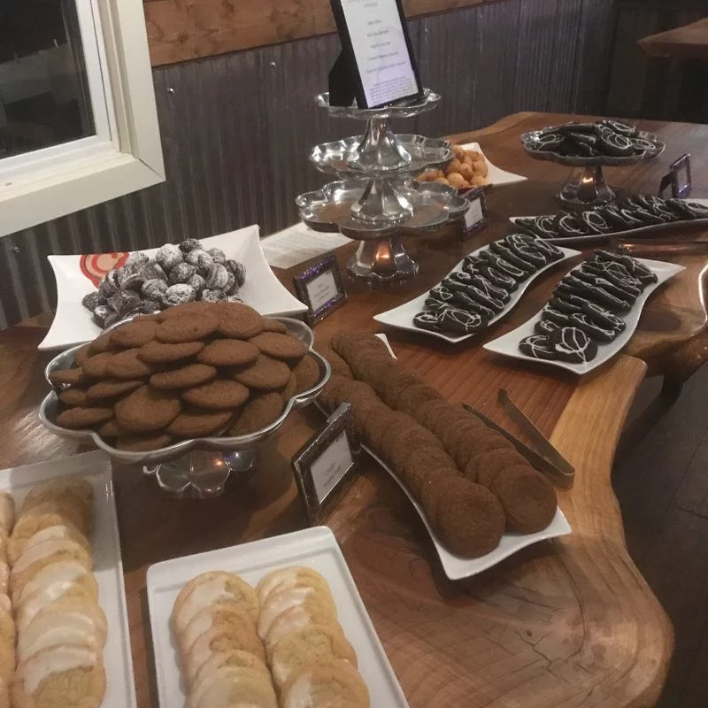 platters of different flavored cookies at wedding dessert bar