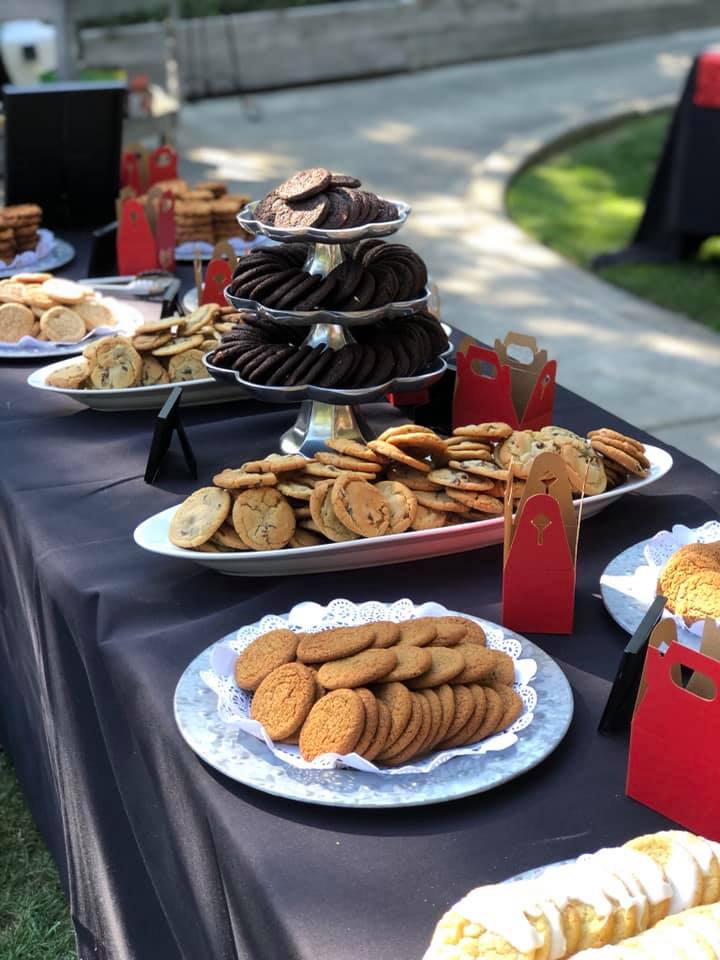 platters of cookies on table with black table cloth