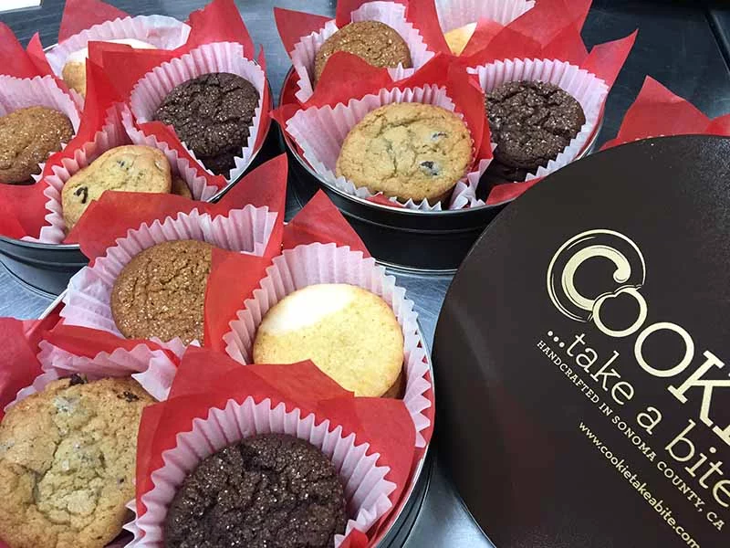 Different flavored cookies made with local ingredients in gift tins