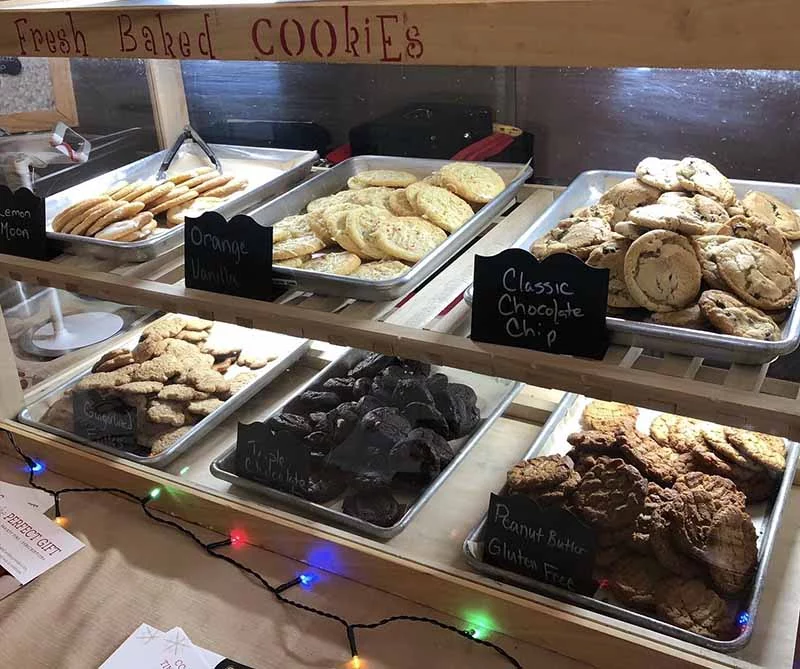 bakery display of festive holiday cookies with christmas lights