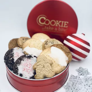 open cookie tin overflowing with a variety of cookies, holiday ornament