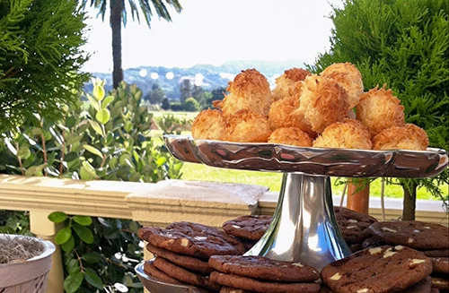 A tiered cookie display at a wedding with multiple fresh baked cookies