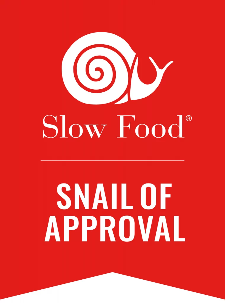 Snail of Approval badge from Slow Food with white snail on red background