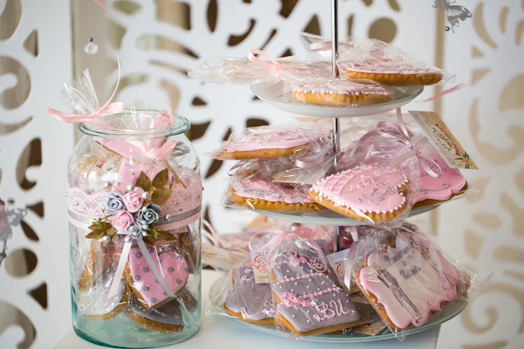 Custom cookie wedding favors decorated with the bride and groom wedding theme and individually wrapped for guests to take home