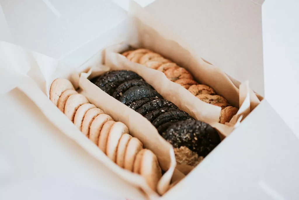 A box of locally made gourmet cookies against a white background.